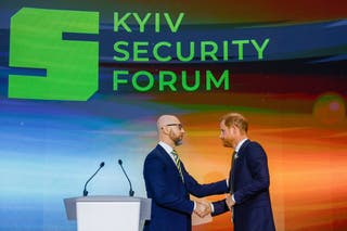 Prince Harry shakes hands with Kyiv Security Forum Chair Arseniy Yatsenyuk at the start of the forum in Kyiv